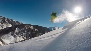 A snowboarder on a snowy mountainside