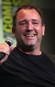 Actor, producer, and director Trey Parker holding a microphone