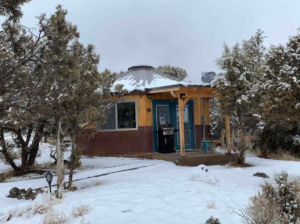 Exterior view of "The Solargon," a unique yurt-hogan-lodge home