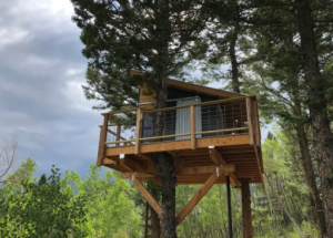 A unique elevated treehouse in the Colorado forest