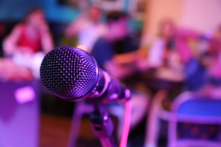 A microphone and audience in a room at a Denver karaoke establishment