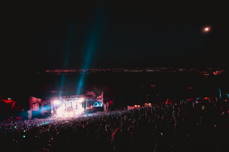 Red Rocks Amphitheatre at night, with a band playing on the stage