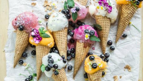 Several colorful ice cream cones lying on a white cloth