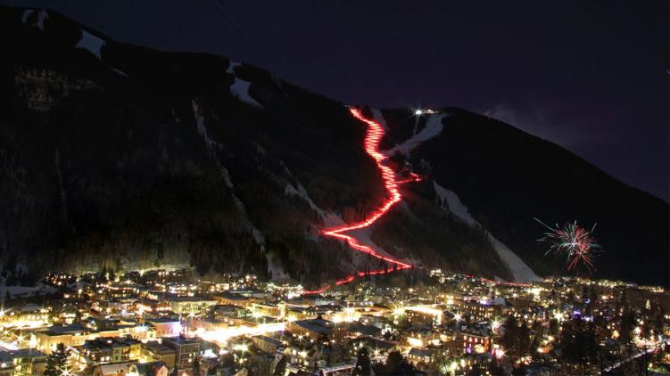 The red glow of lit torches on the mountain during a favorite New Year's Eve in Colorado, the Telluride Torchlight Parade